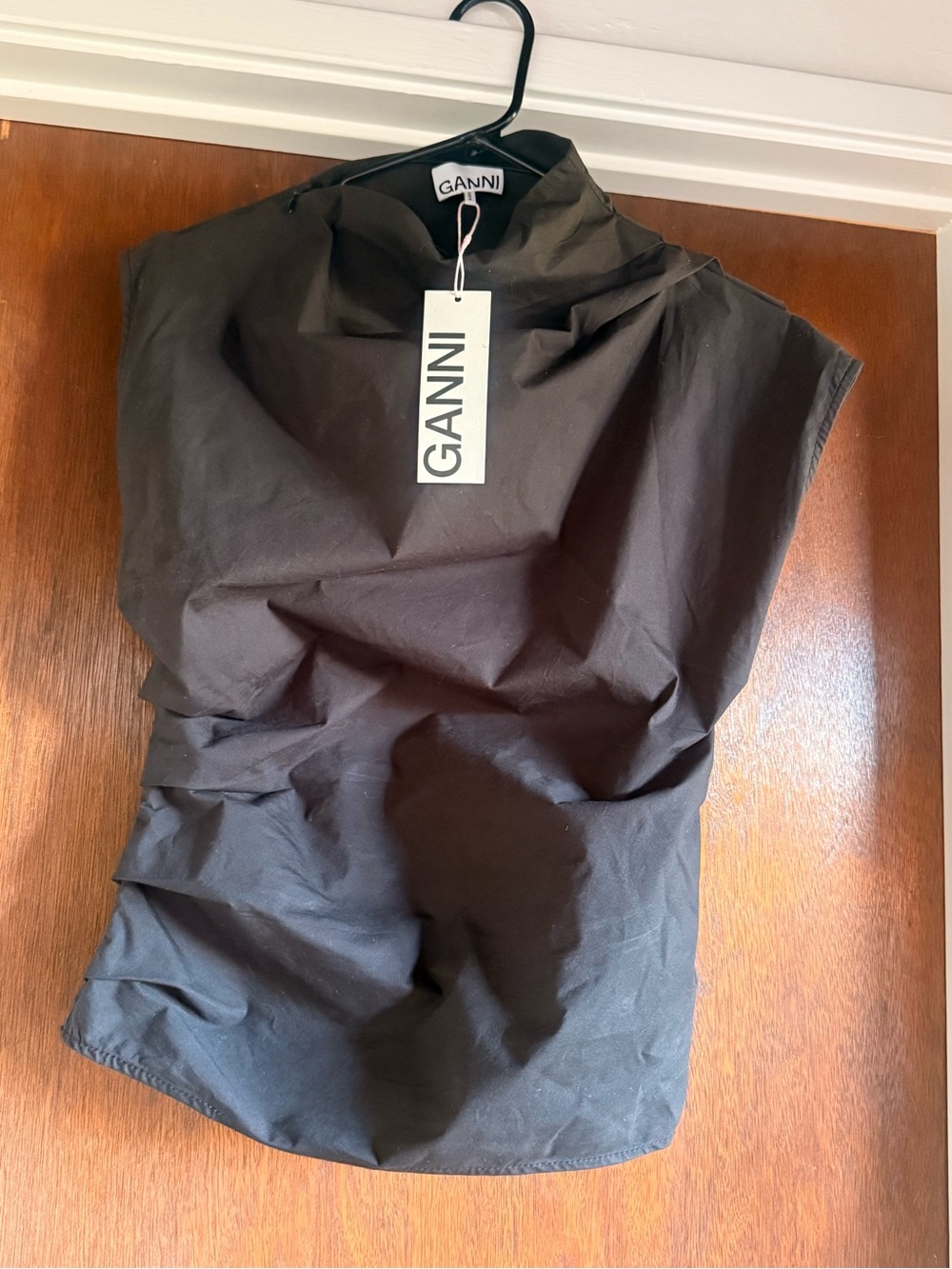 GANNI asymmetrical sleeveless blouse with peekaboo back and mock turtleneck